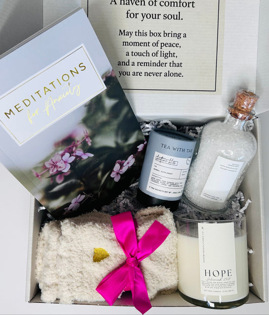 Anxiety and Peace Box showing 31-day meditation booklet, Nighttime Routine Sleep Tea by Tea with Tae, lavender bath salts, Hope soy candle with Jeremiah 29:11 verse, and cozy socks arranged together