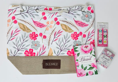 Blessed care box contents laid out showing You Are Blessed softcover devotional book, Favorite Bible Verses to Bless Your Heart Box of Blessings cards, Blessed canvas tote bag with rope handles and Butterfly Blessings mini magnetic bookmark set for gratitude and encouragement