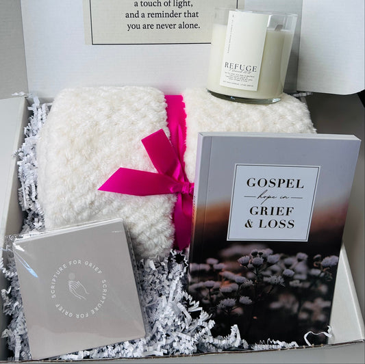 Grief and Comfort Care Box showing scripture verse cards, Gospel Hope in Grief journal, Refuge soy candle with 2 Samuel 22:31 verse, and cozy soft blanket arranged together