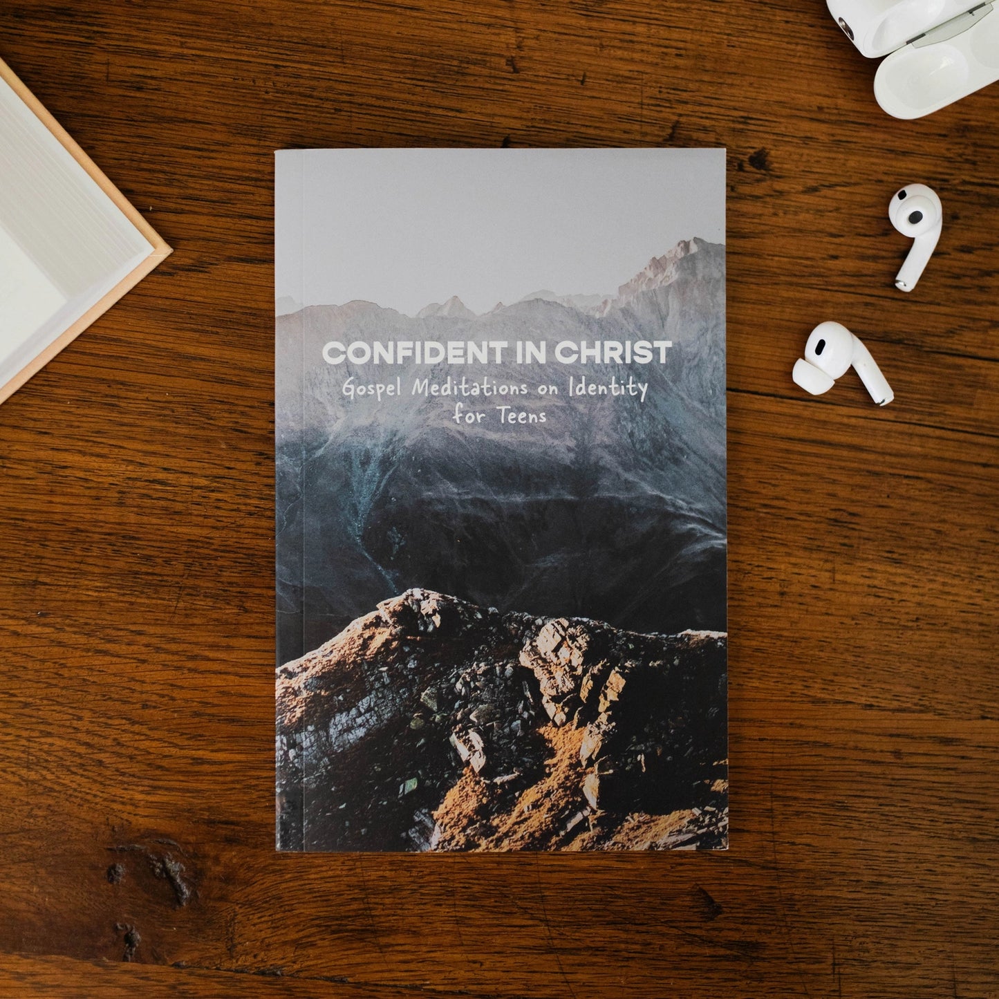 Front cover of Confident in Christ Gospel Meditations on Identity for Teens with mountain landscape illustration included in Teen Boy Blessing Box