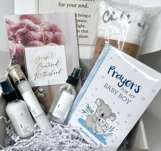 New Mom & Baby Boy Blessing Box with all 6 items displayed inside the Soul Haven gift box including Gospel-Centered Motherhood Devotional, Prayers for My Baby Boy Prayer Book, Baby Muslin Swaddle Blanket Child of God, Mini Lavender Bath Salts, Mini Lavender Body Lotion and Mini Linen Spray