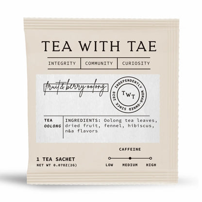 Tea package with 'Tea with Tae' branding and tea ingredients information on a white background inside a vanilla colored sachet.