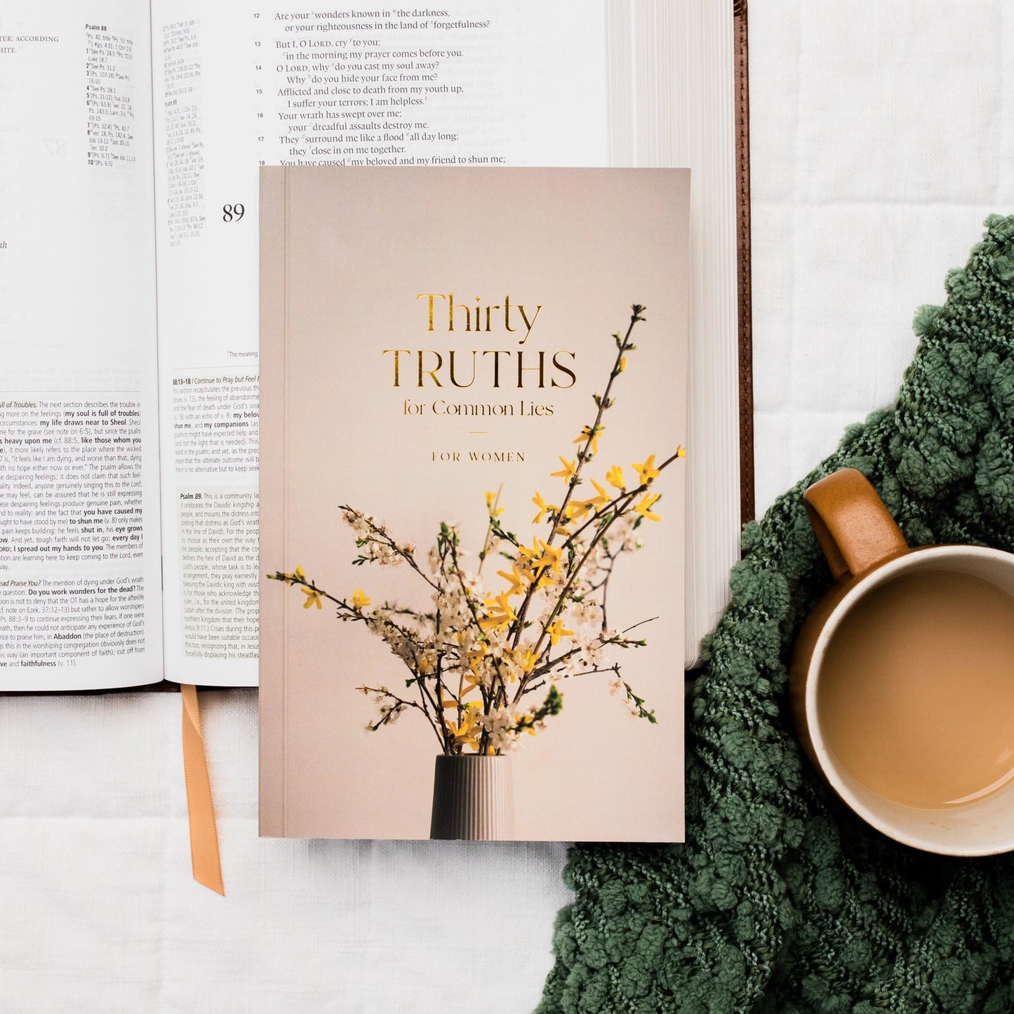 Front cover of Thirty Truths For Common Lies For Women devotional resting on an open Bible